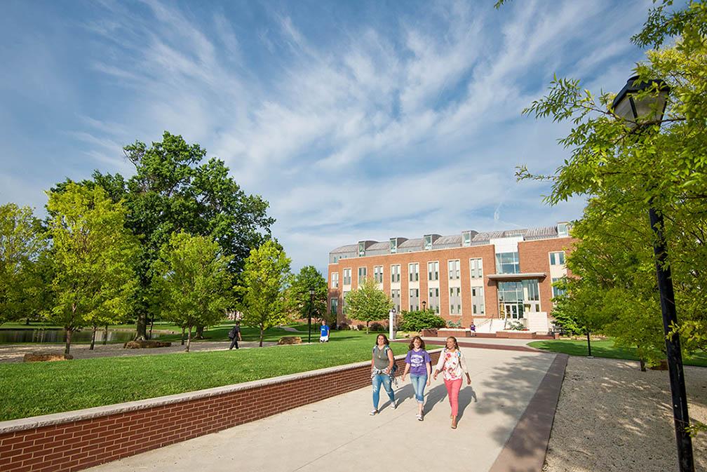 three students walking on campus